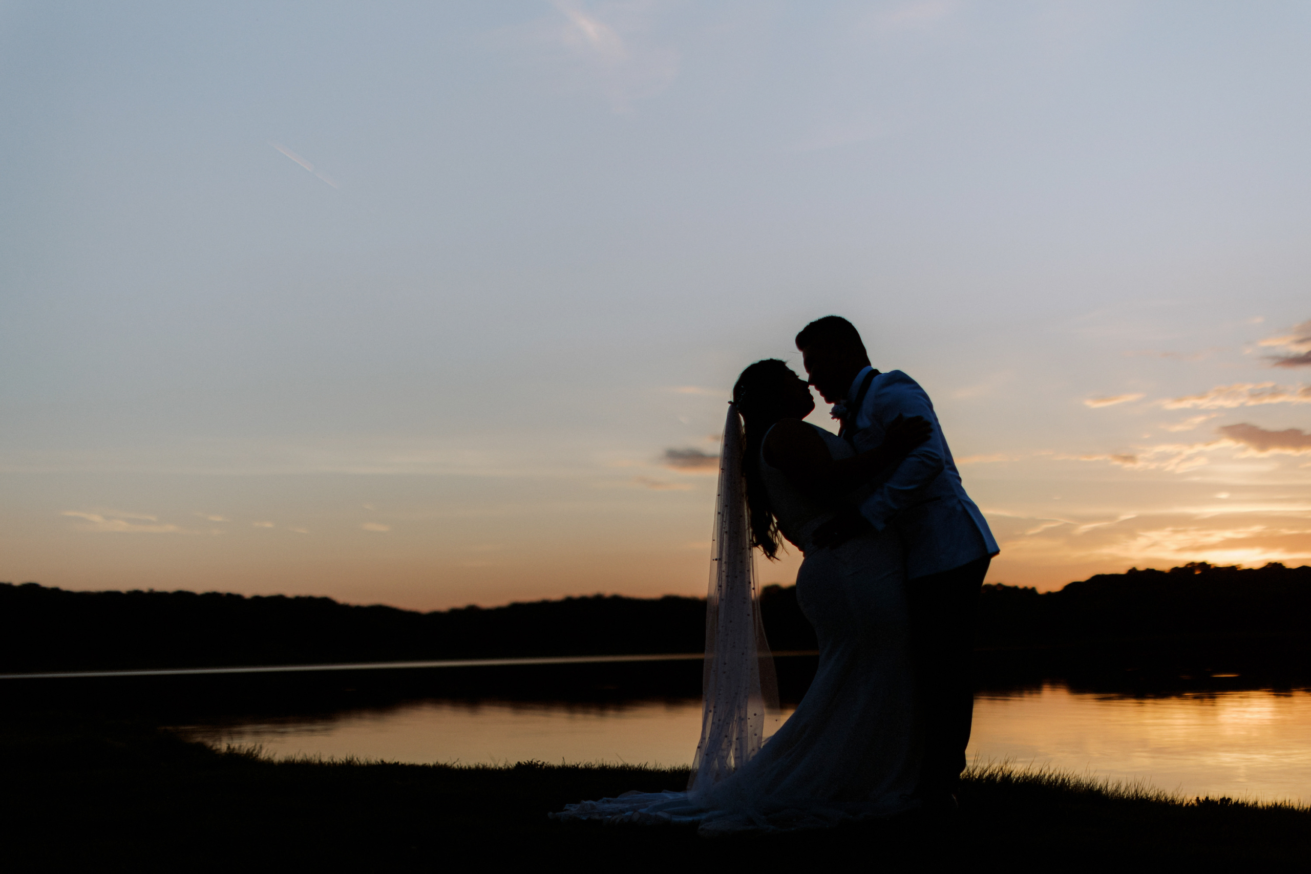 bride and groom sunset photo over looking the lake